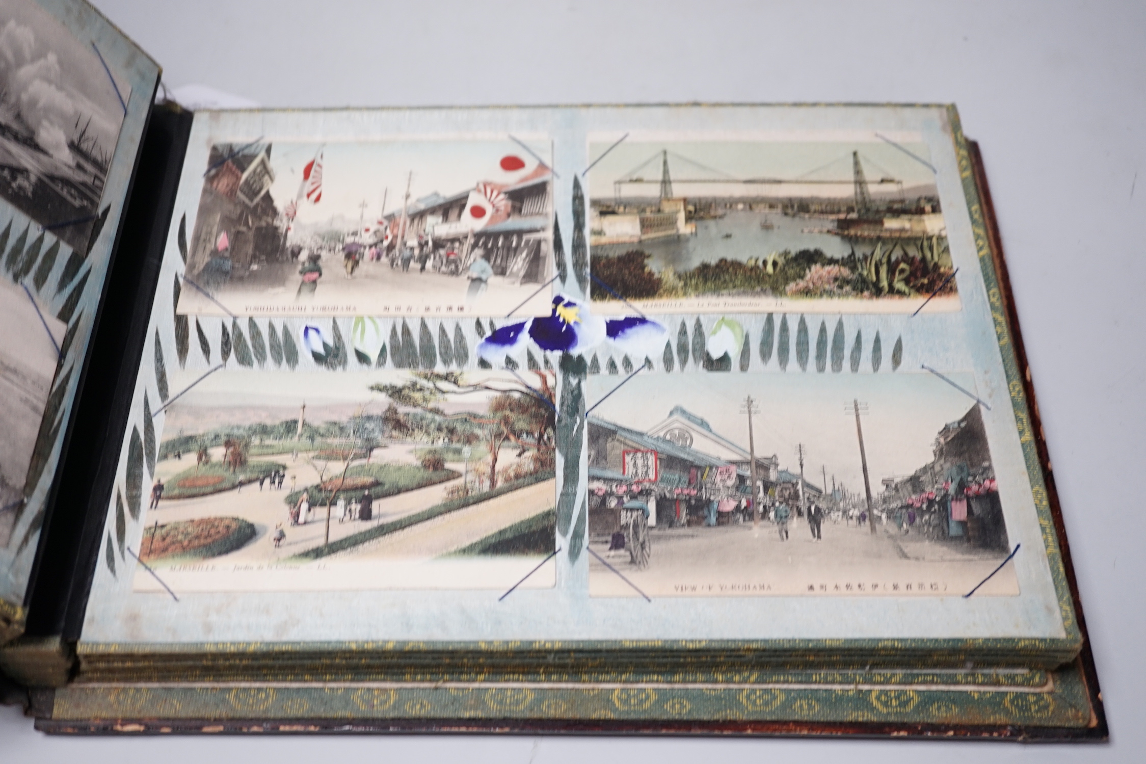 A Japanese photo album with handcoloured postcards of Japan, Ceylon, India etc.